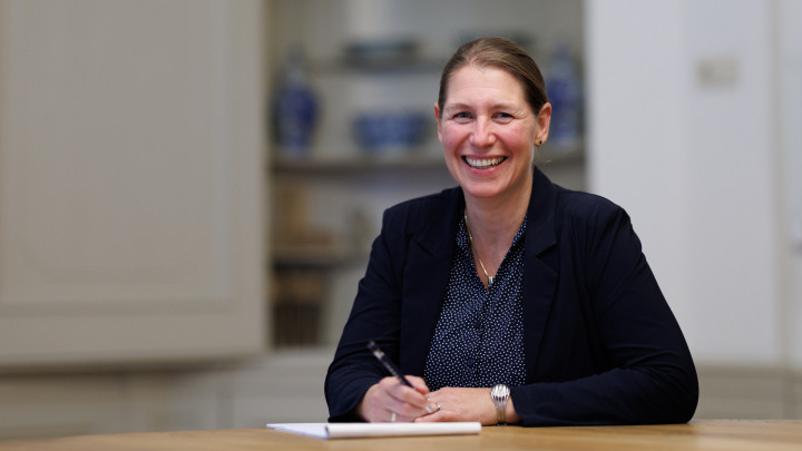 Portretfoto van Maartje Nonhebel aan een bureau