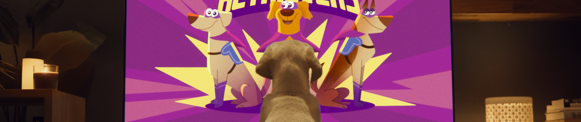 pup kijkt naar still uit de animatievideo waarbij 3 getekende retrievers als superheld te zien zijn