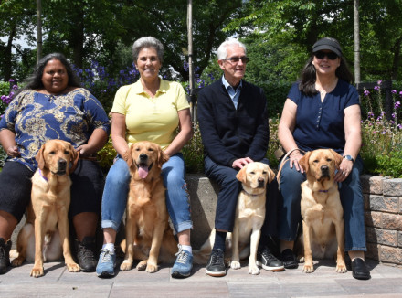 Groepsfoto schoolinstructie met instructeurs, 4 hondenbazen en hun geleidehonden